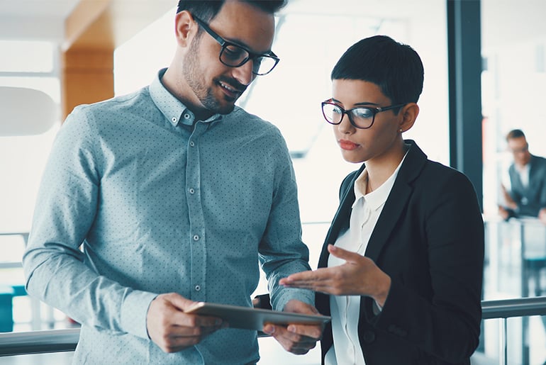 woman and man looking at a tablet